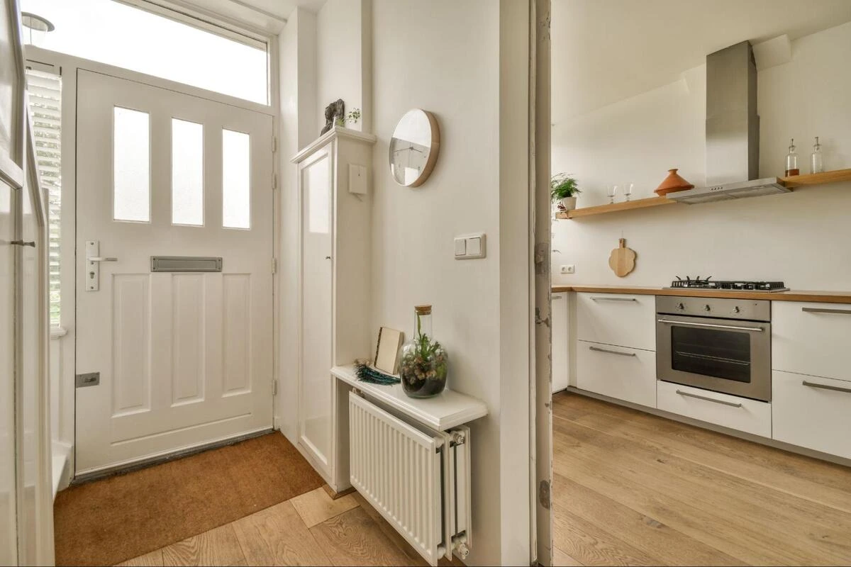 Modern home interior showing kitchen directly visible from the front door, illustrating a common feng shui taboo