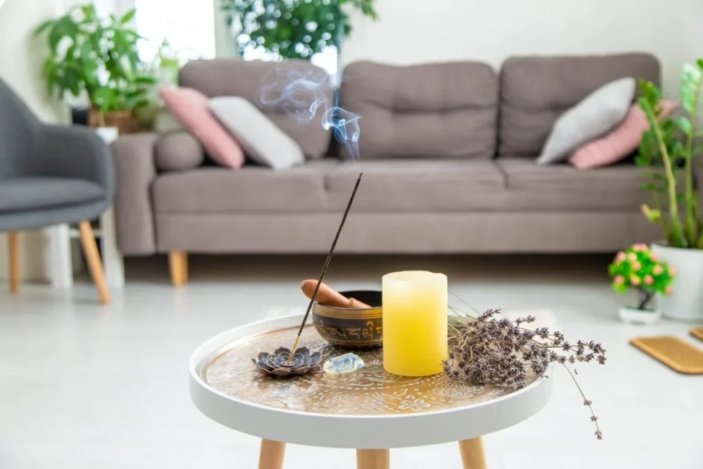 A calm Singapore living room with incense, a singing bowl and natural light