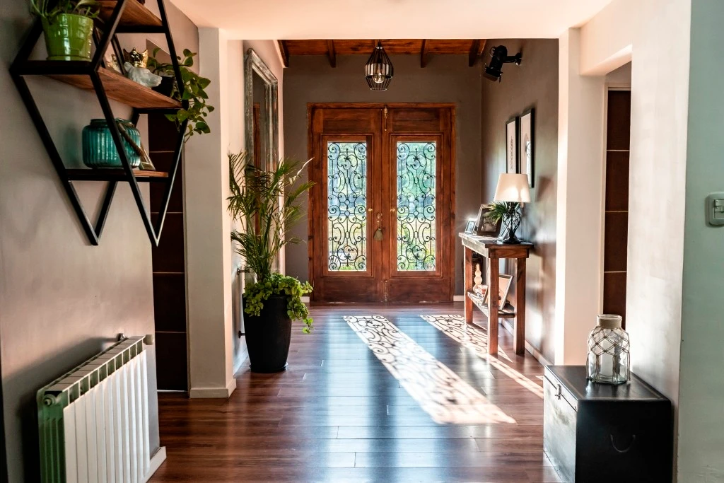 A bright entryway with a panelled front door opening into the home